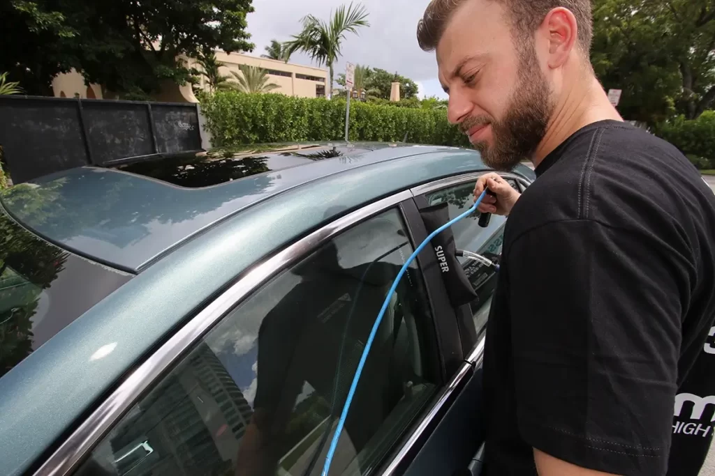 our locksmith is opening a locked car door in Miami FL
