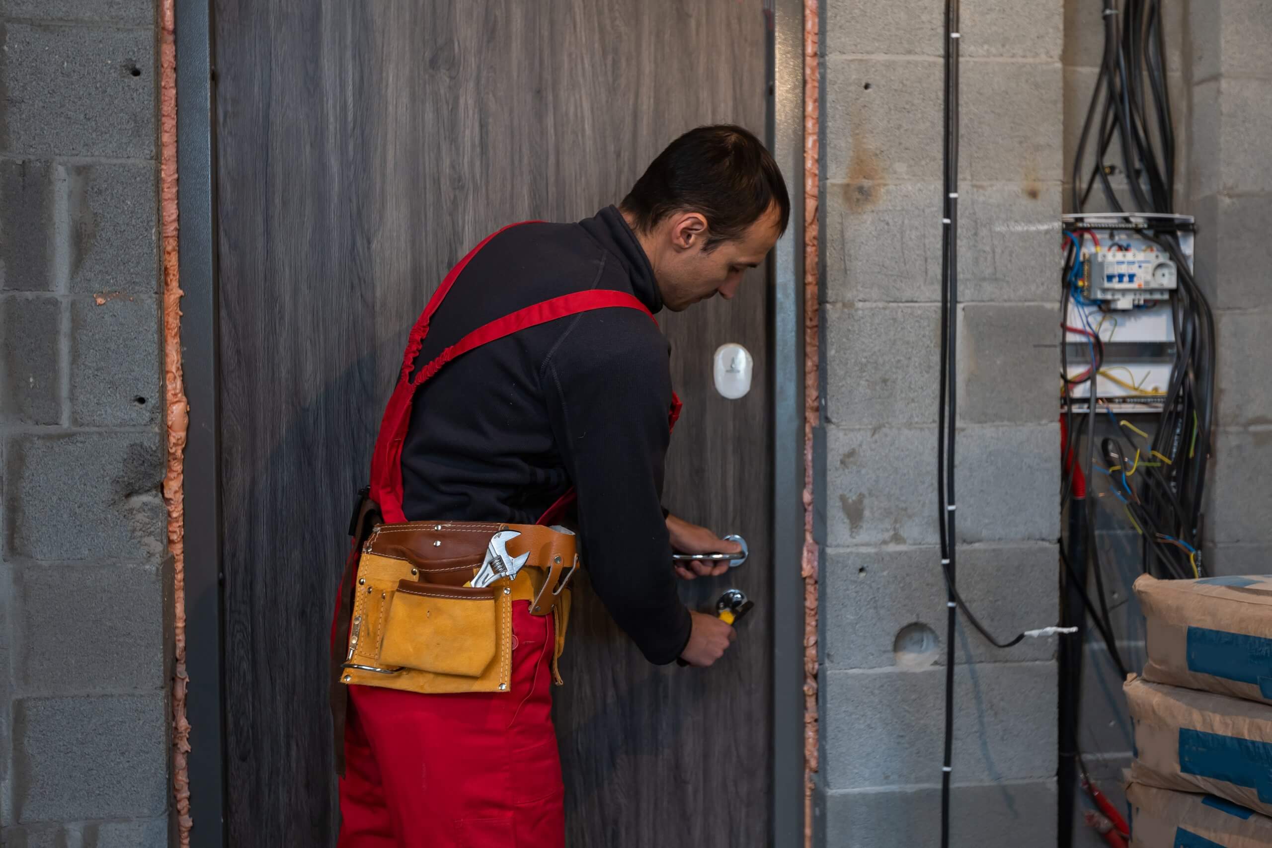 a locksmith fixing the door