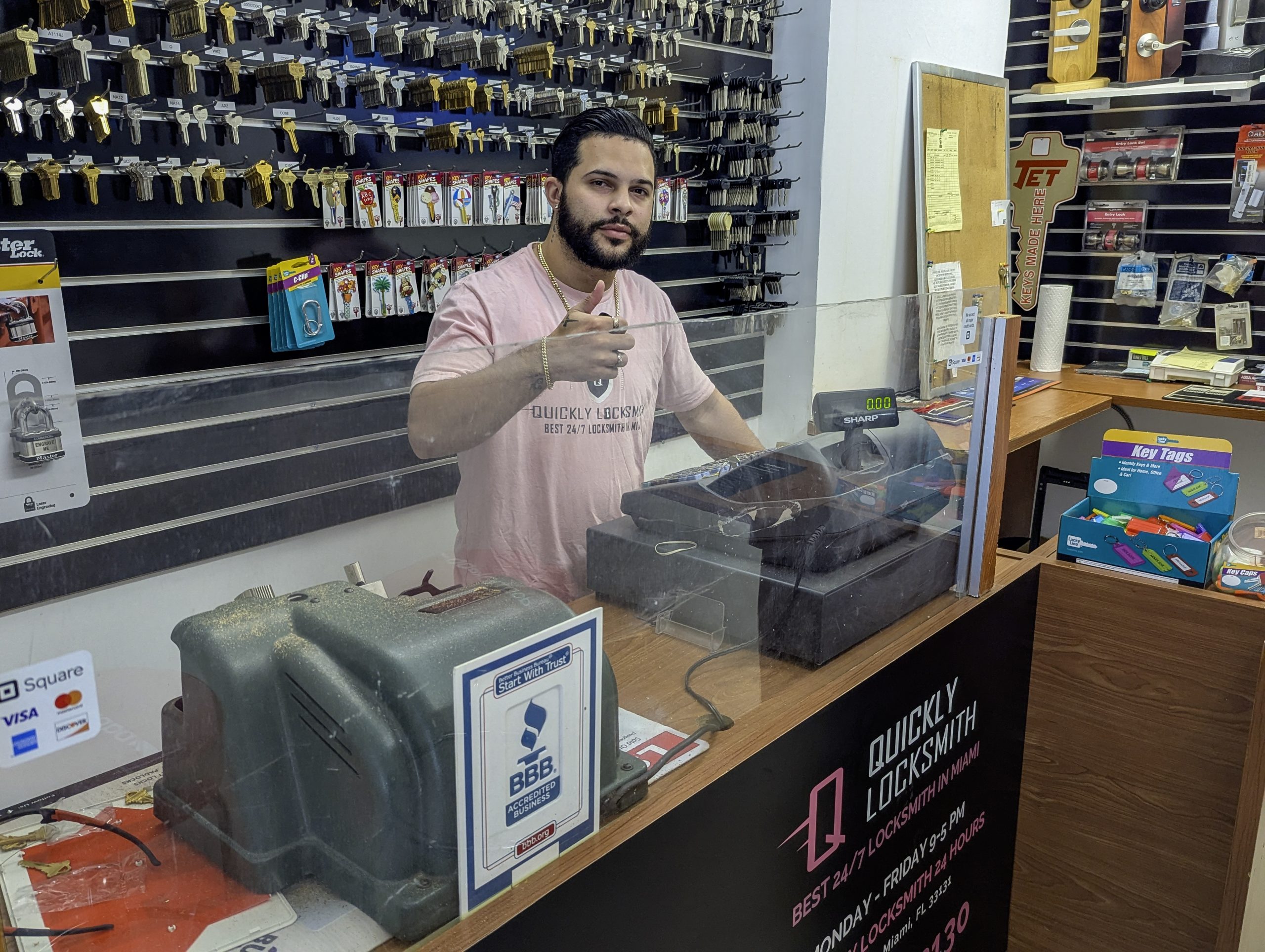 Locksmith technician assisting a customer at the Downtown Miami Quickly Locksmith front counter.