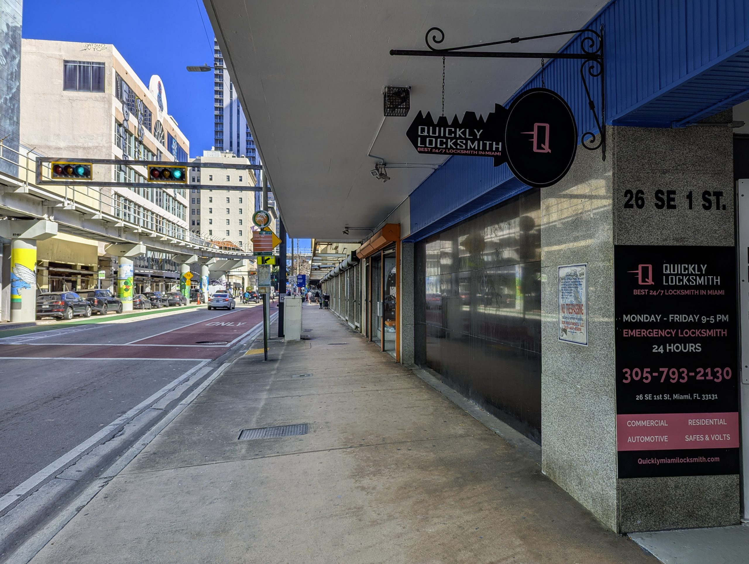 Sidewalk view facing east toward the Quickly Locksmith Miami Downtown storefront.